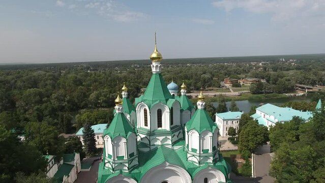 Svyatogorsk, Ukraine - August 19, 2021: Aerial view on domes of the Svyatogorsk monastery central temple overlooking the city and the Seversky Donets river