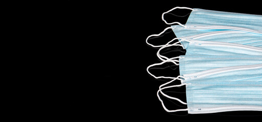 Disposable  ear-loop face mask 3 ply, Safety masks on black reflective background. Copy space. Dust...