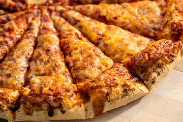 Closeup of a. delicious pizza being Served at a buffet for an outdoor social event.