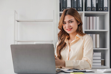 Business woman using calculator for do math finance on wooden desk in office and business working background, tax, accounting, statistics and analytic research concept..