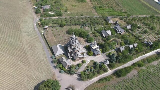 Svyatogorsk, Ukraine - August 19, 2021: Aerial circular view of the wooden skete in the Svyatogorsk monastery.