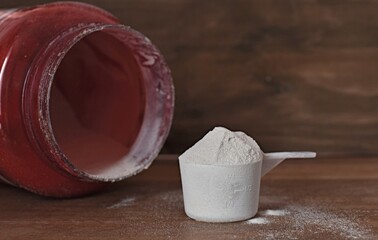 jar red with protein powder on wooden table
