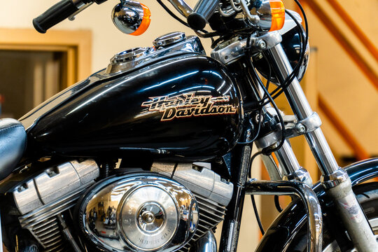 close-up of modern Harley Davidson motorcycles for sale parked in front of the shop of the motorcycle dealer