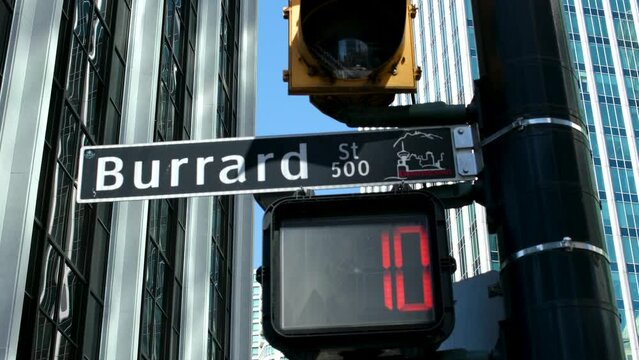 office buildings streets at Burrard Station people rushing to work trolleybus taxi car traffic lights. men and women cross street get into public transport city life Canada Vancouver 12.04.2023