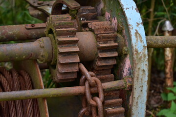 Rusty metal mechanical parts in the grass 