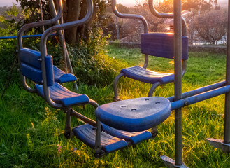 Empty swings at sunset. Portugal.