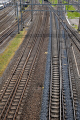 Obraz premium Several empty parallel train tracks in major rail hub in European city. Above view, trains, no people