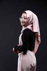 Cute young Asian hijab corporate girl with smooth glowing skin smiling and relaxing over an isolated background studio. Beauty skin care, office concept.