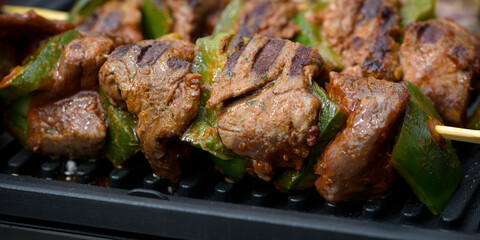 view of beef being cooked on a griddle