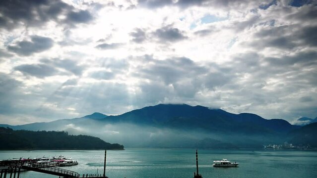 The "Crepuscular Ray" moved and illuminated the blue surface of the lake. The mountain and lake scenery of Sun Moon Lake in the morning.  Nantou, Taiwan