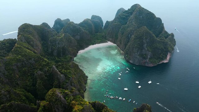 Drone aerial view at Phi Phi Island Maya Bay Thailand. Aerial shot of beautiful tropical beach surrounded by limestone cliffs at sea. Island Ko Phi Phi Lee with famous Maya Bay, aerial shot