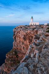 Fototapeta na wymiar Vista del faro del cabo Cavallería en la costa de Menorca, islas Baleares, España.