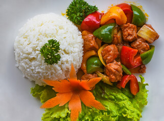 Stewed beef with vegetables and rice isolated on black background top view