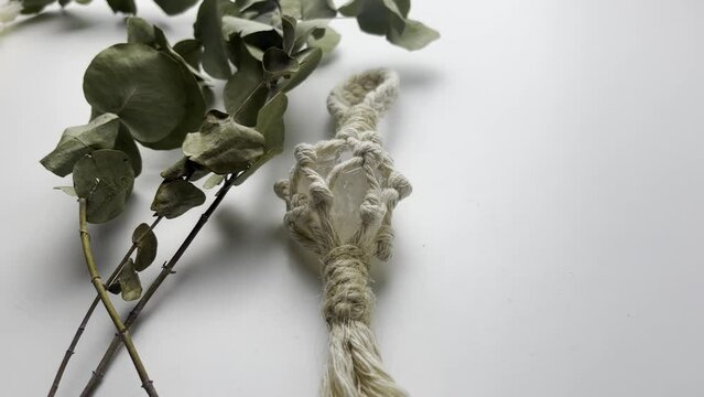 handmade macrame keychain design in natural colours.boho style quartz and knots. on white background. Close up video. Slow motion video. stock footage