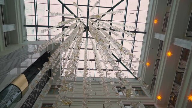 Interior of atrium in hotel building. Decoration on the ceiling. Crystal glass drops. Shining crystals in the interior on top.