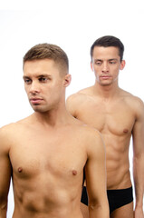 Two young attractive guys are posing in the studio. Beautiful gay couple in a relationship. Love and romance.