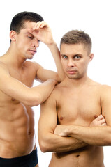 Two young attractive guys are posing in the studio. Beautiful gay couple in a relationship. Love and romance.