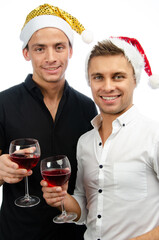 Two young attractive guys are posing in the studio. Beautiful gay couple in a relationship on holidays with gifts. Love and romance.