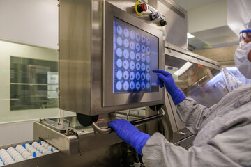 Cheking eggs in automatic harvester system for vaccine producing.