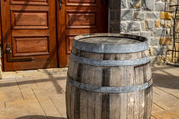 Wine barrel near the carved door of the winery