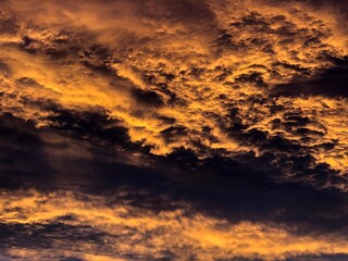 Fototapeta na wymiar Storm clouds highlighted with setting sun
