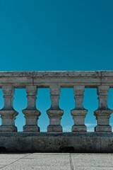 Fototapeta na wymiar Stone railing against a blue sky