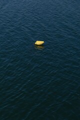 Yellow buoy floating on sea surface