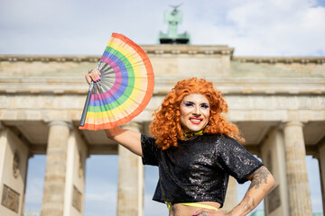 Drag queen with rainbow fan at the Brandenburg Gate in Berlin, Pride month © Amparo Garcia