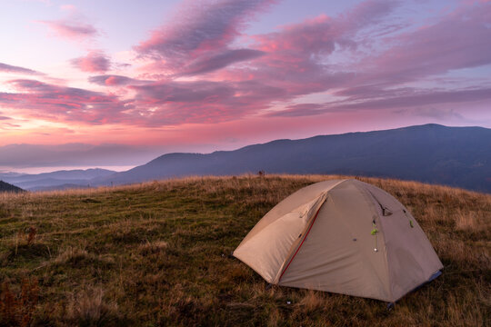 Beautiful sunrise. Tourist tent on the top of the mountain. Beautiful landscape and sunrise. Base tourist camp.