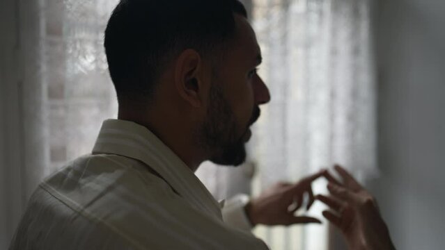 Back of Angry young man in discussion with someone else off camera. Frustrated emotion of a person counting the number of mistakes with hand