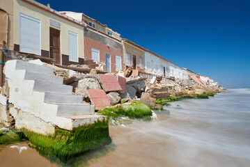 Damaged houses at the coast due to global warming