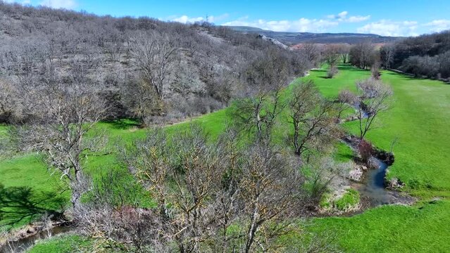 Meanders in the Lucio River in Renedo de la Inera. Aerial view from a drone. Recuevas Valley. World geological heritage UNESCO. Las Loras Geopark. Palencia. Castile and Leon. Spain, Europe
