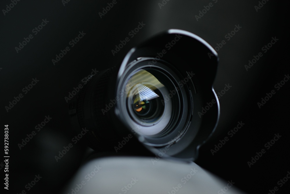 Sticker Lens of a camera isolated on the dark blurred background