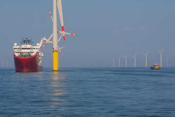 Support vessel and crew transfer vessel working on offshore wind farm  - obrazy, fototapety, plakaty