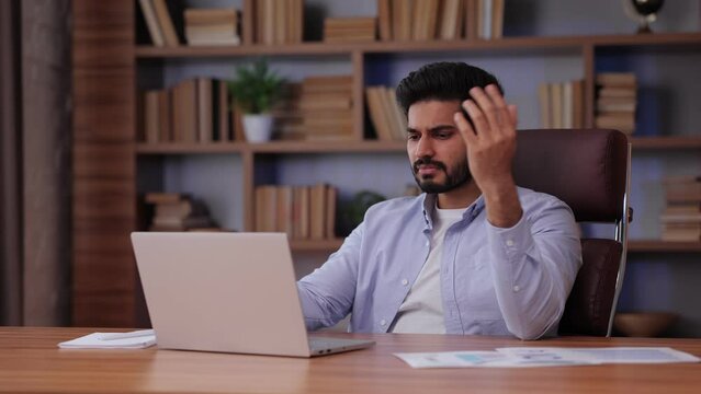 Angry entrepreneur disappointed failure at workplace closeup. Businessman feeling stressed at office. Nervous man using computer.