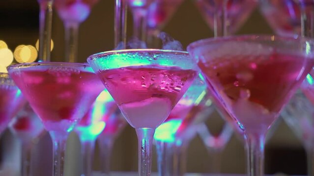Tower of glasses at celebration party. Welcome drinks, tower of champagne or sparkling wine with red berry. Restaurant ready for reception. Alcoholic beverage.
