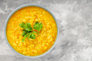 Bowl of lentil soup on concrete. Red lentil soup with fresh parsley. Traditional turkish or arabic...