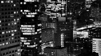 Fototapeta na wymiar View of at night glass buildings and modern business skyscrapers,. View of modern skyscrapers and business buildings in downtown. Big city at night. Black and white.