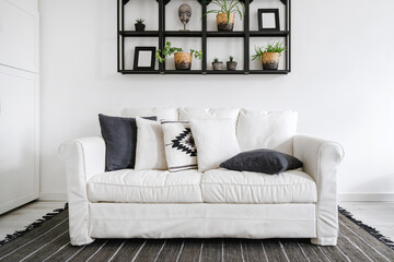 white couch with decorative pillows in lounge room with boho design