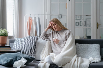 sick and upset woman staying at home with headache and influenza