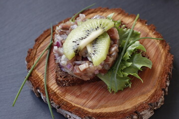 Herring tartare on a slice of rye bread