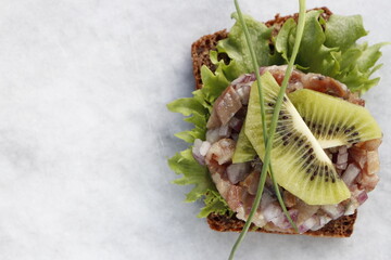 Herring tartare on a slice of rye bread