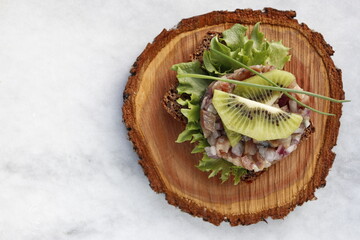 Herring tartare on a slice of rye bread