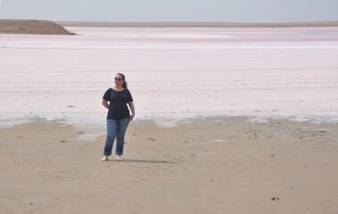 A woman stands on the shore of the Mekletinsky salt lake. Reserve Chernye zemli. Kalmykia. Russia