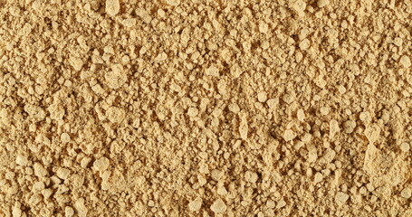 Ginger powder background and texture, top view