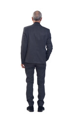 Obraz premium back view of a man standing with suit and one hand pocket on white background