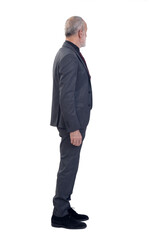 side view of a man standing with suit and tie and  look at the bottom on white background