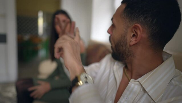 Couple's relationship troubles escalate into heated argument. Young man and woman yelling during verbal altercation. Emotional crisis between partners. Anger and frustration in romantic relationship