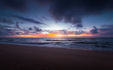 Fototapeta na wymiar sunrise with dramatic clouds on the beach