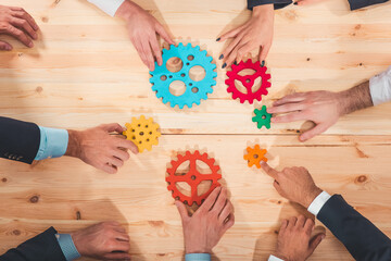 Obraz na płótnie Canvas Business team connect pieces of gears like a teamwork and partners